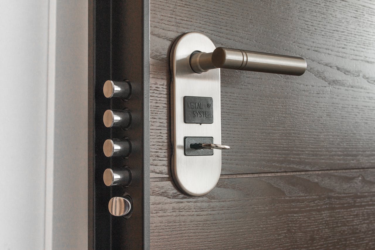 gallery-04 Metal door handle and lock system with key inserted, showcasing security features.